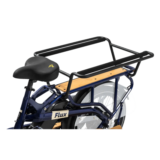 A sleek eBike Revi Flux ST in a studio setting, showcasing its modern frame design, integrated battery, and upright handlebars.