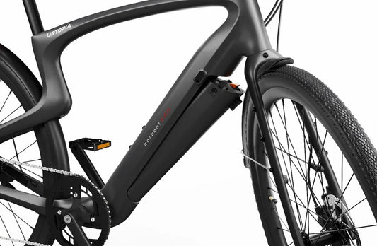 Side view of the Urtopia Carbon 1 Pro eBike in matte black, showcasing its lightweight carbon fiber frame, integrated display, and sleek, minimalist design against a white background.