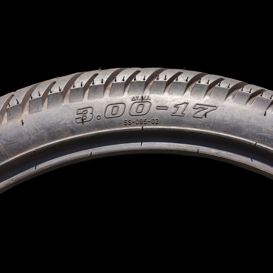 eMOTO Vuro Star 3.00-17 17-inch tire, side view, black tread with visible branding