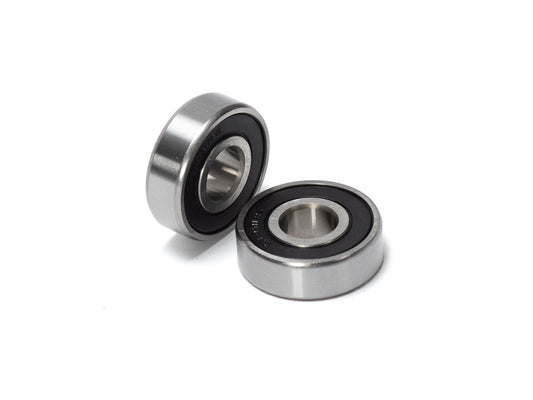 Close-up view of Stomp Ebox Dragster wheel bearings, showing two metal ball bearings on a white background.