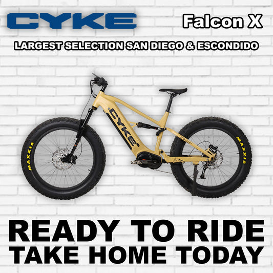 Desert yellow Cyke Falcon X e-bike, side view, against a neutral background