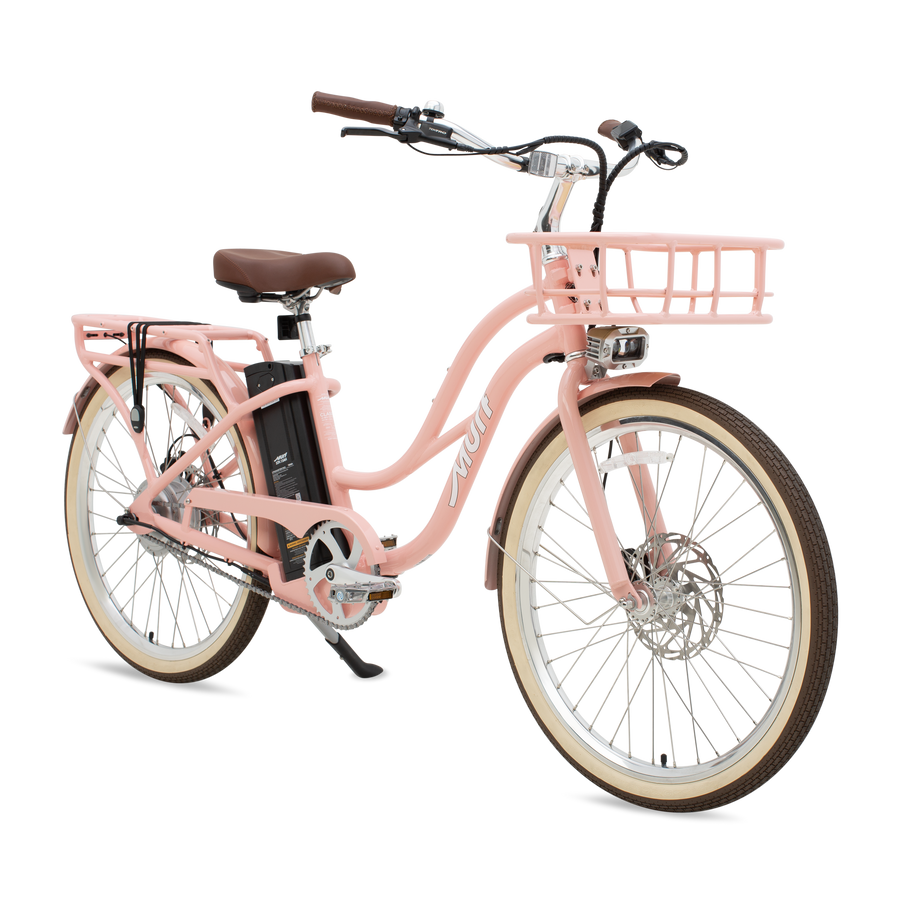 A peach-colored Murf Gigi eBike parked on a sandy beach with the ocean in the background.