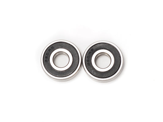 Close-up view of Stomp Ebox Dragster wheel bearings, showing metal bearing components arranged on a white background.