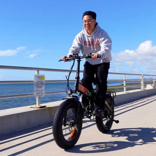 Side view of the FREEGO eFlex Raptor E1 electric folding fat tire eBike in step-over design, featuring a sturdy black frame, thick tires, and a 750W motor.